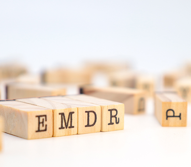 Wooden letter blocks spelling EMDR, one approach used in PTSD therapy in Toronto